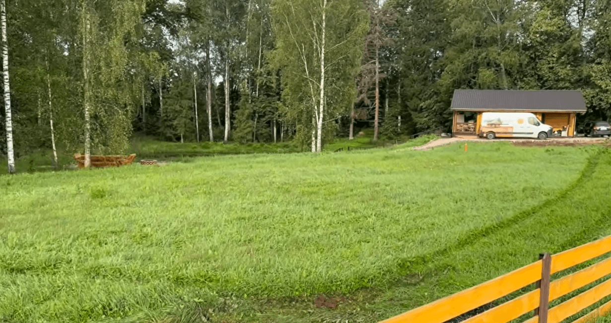 Before: Overgrown grassy field with brush and weeds